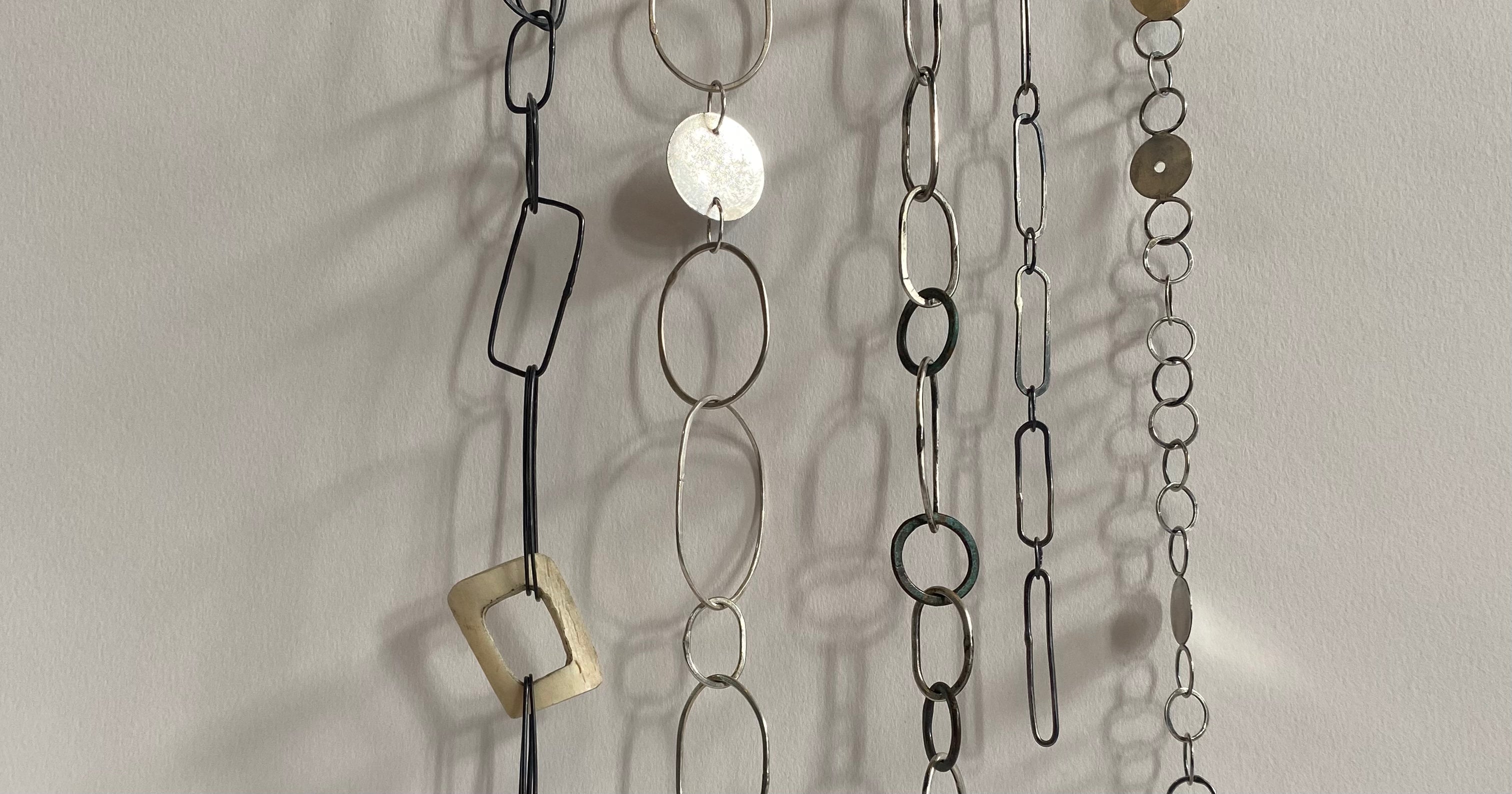 Decorative chain with various links on a plain background
